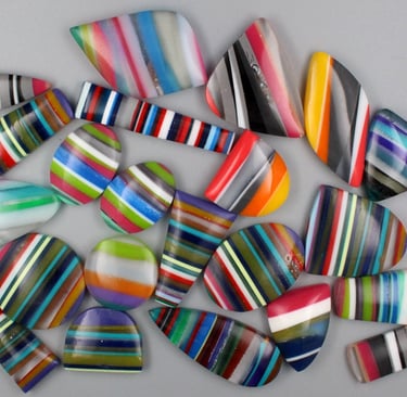 Surfite cabochobs made from upcycled surfboards in bright colours and shapes