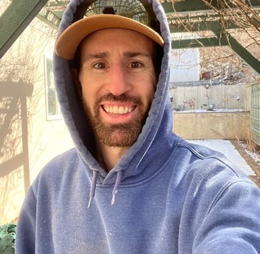 a man in a blue hoodie and a hat