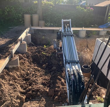 Excavator digging to build a retaining wall