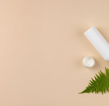cosmetics with beige background and tree leafs