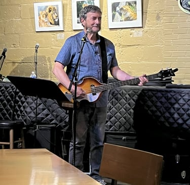 Dave of Crossmolina Band playing his Hofner bass at the Little Theater Cafe.
