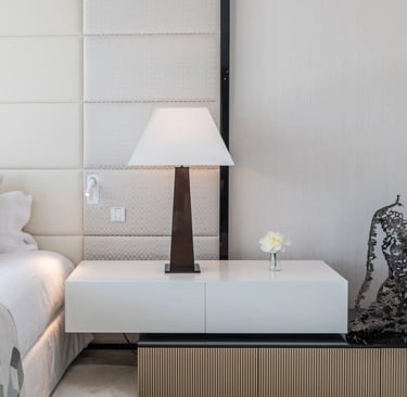 Modern bedside table with lamp and sculpture at Villa Serenity