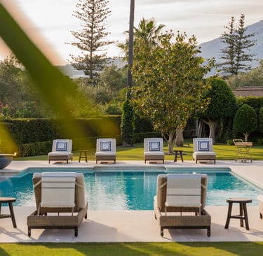 Sunlit pool terrace with lined sunbeds