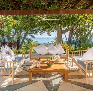 Covered terrace lounge with sea views and outdoor seating