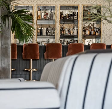 Cocktail bar at Villa La Gratitud with custom cabinetry and velvet seating