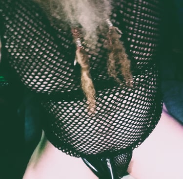 a man dressed in a mesh top in a g-string