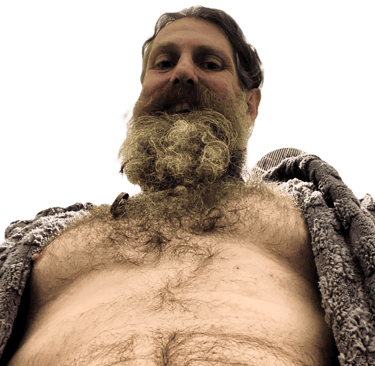 Axel TheBeast with an open robe looking down at the camera in a dominant way