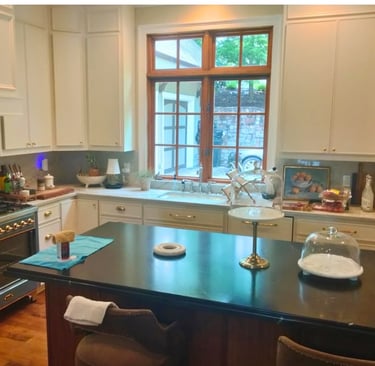 Modern kitchen with black granite island and window over sink