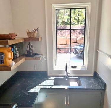 Laundry room sink with dark granite countertop in Asheville, NC