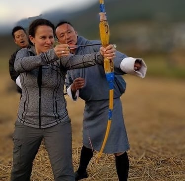 drukyul_delights_ceo_with_guest_experiencing_archery_session_in_punakha_bhutan