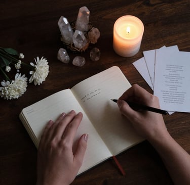 New moon intention setting ritual with journal candle and moonstone crystals