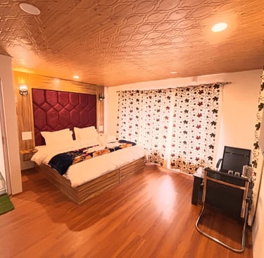 A warm room in Kashmir with rich embroidered curtains, a low seating area