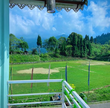 Panoramic view of the mountains from a homestay balcony in Sherpagaon during summer.