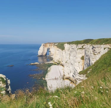 a person standing on a cliff overlooking the ocean