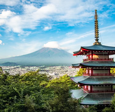 a pagoda in the mountains with a mountain in the background