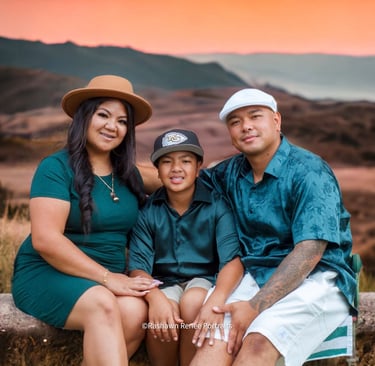 a family of three sitting on a bench in a field for a family Photoshoot