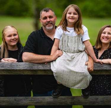 Family portrait of parents and children leaning on a rustic wooden fence. Athens_Ohio_family.jpg