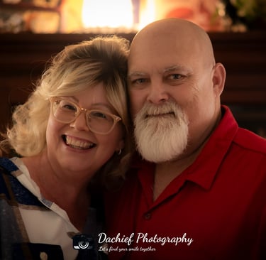 A smiling senior couple posing for a professional portrait by Dachief Photography. Athens, Oh