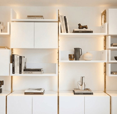 Bespoke wall shelving with bronze frame 