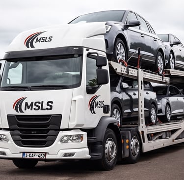 Large MSLS branded car transporter truck hauling a full load of new cars.