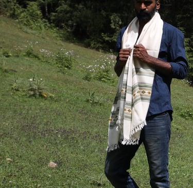 a man  standing in the grass with Vasanth shawl