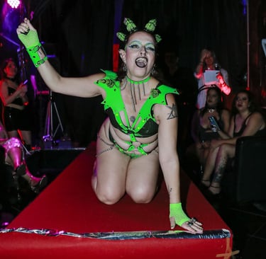 a woman in a green outfit is posing for a photo