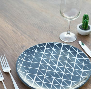 a plate with a cactus plant in the middle of it