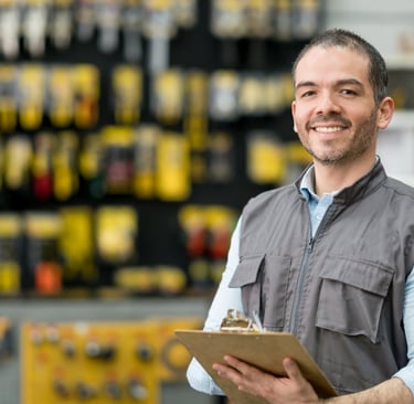 Local business owner in a hardware store holding a clipboard, representing service-based niches for 