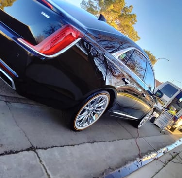 a detailed car parked behind detailing van