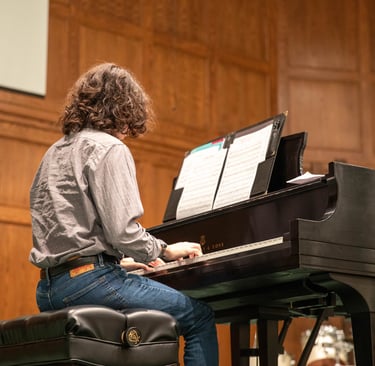 Adult playing at a piano recital