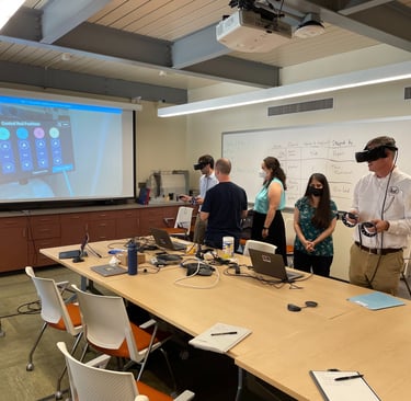 Students wearing VR headsets participate in a virtual reality engineering simulation in a modern classroom.