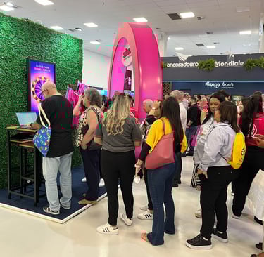a group of people standing around a television screen