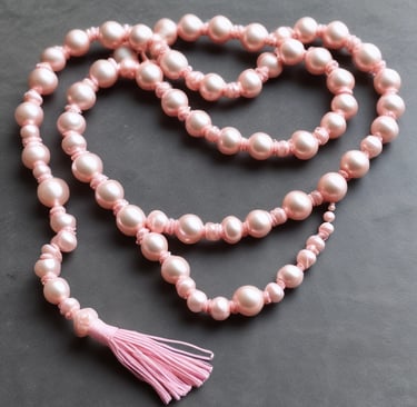 A collection of gold jewelry is set against a vibrant yellow background. The pieces include a ring, earrings, and a necklace, all designed to resemble a ginkgo leaf. The shiny metallic finish of the jewelry contrasts with the matte yellow surface.