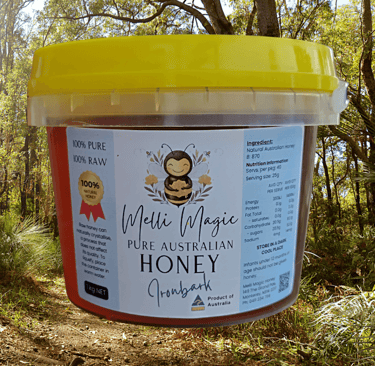 Melli Magic 1kg tub of pure raw Australian Ironbark honey set against a sunny forest background.