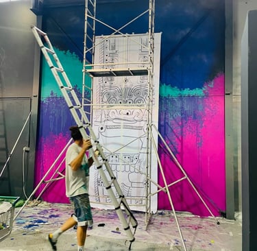 un homme qui porte une échelle devant une fresque en cour de création