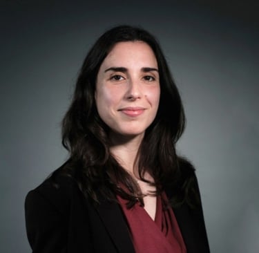 a woman in a black jacket and red shirt (Rita Gomes)