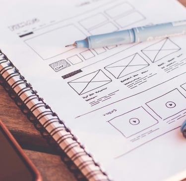 a notebook with a pen on a wooden table
