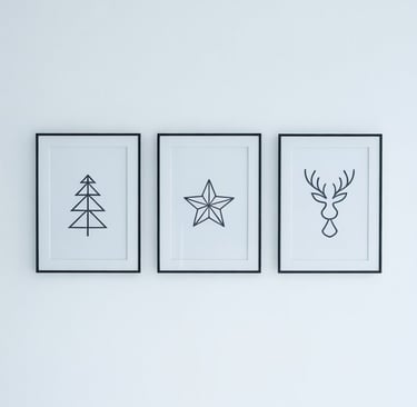 three framed prints of a deer and a christmas tree