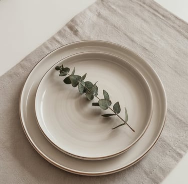 a plate with a leafy branch on it