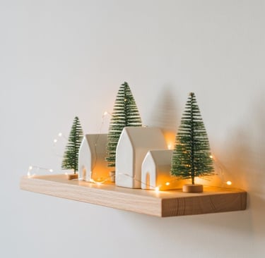 a small christmas tree on a shelf above a shelf