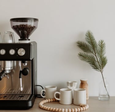 a coffee maker on a counter top with coffee beans and coffee