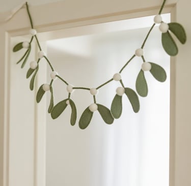 a garland of eucalyptus leaves hanging from a door