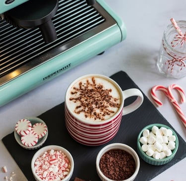 a cup of coffee and candy canel on a table