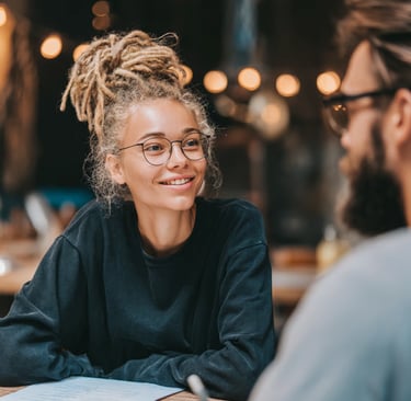 Woman sitting down with her financial planner in coffee shop