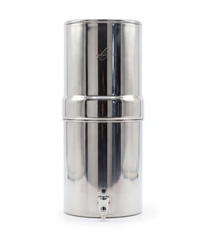 A countertop stainless steel gravity water filter system with a spigot for clean drinking water.