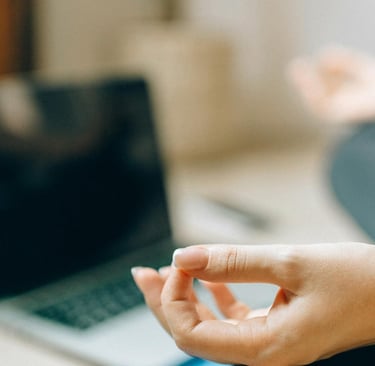 woman meditating with computer