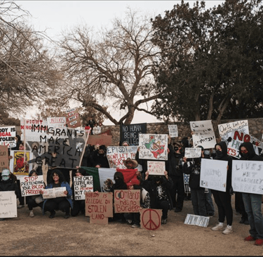 a group of people holding up signs and holding up signs