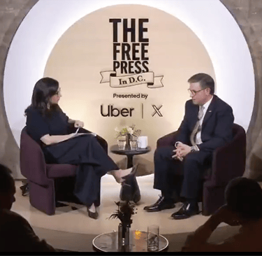 a man and woman sitting in chairs in a room