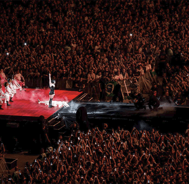 a group of people standing on a stage with a stage