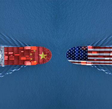 two ships are seen from above, with a flag on the bottom
